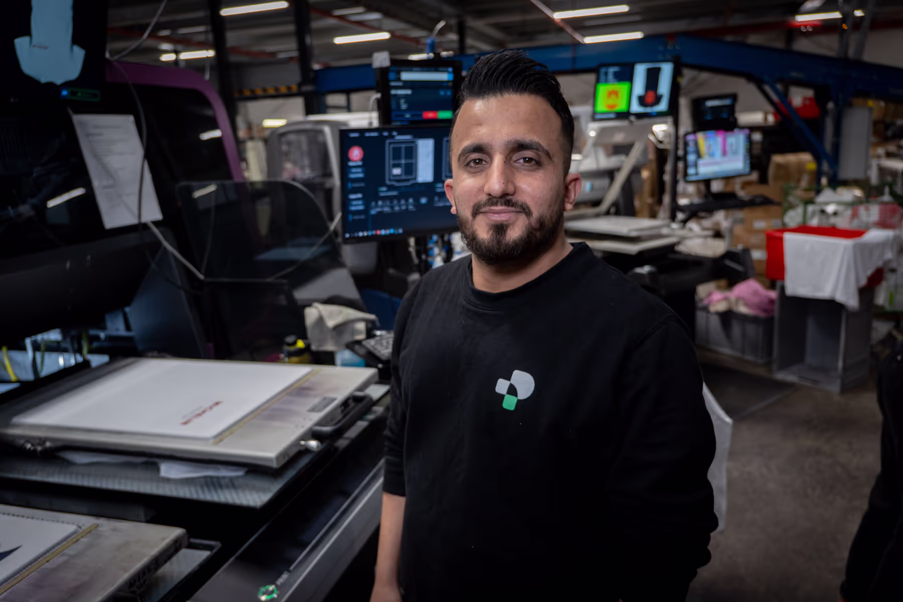 Printing operator standing in front of textile printing machine